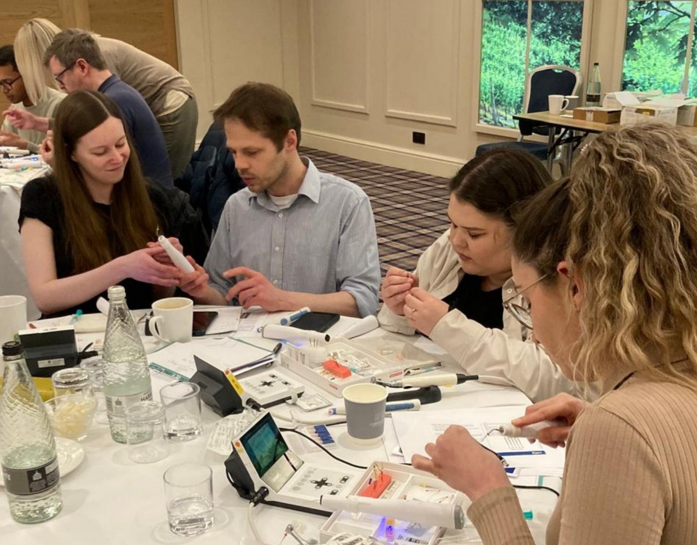 GDPs at a hands-on endodontic training course, working with dental instruments at the table