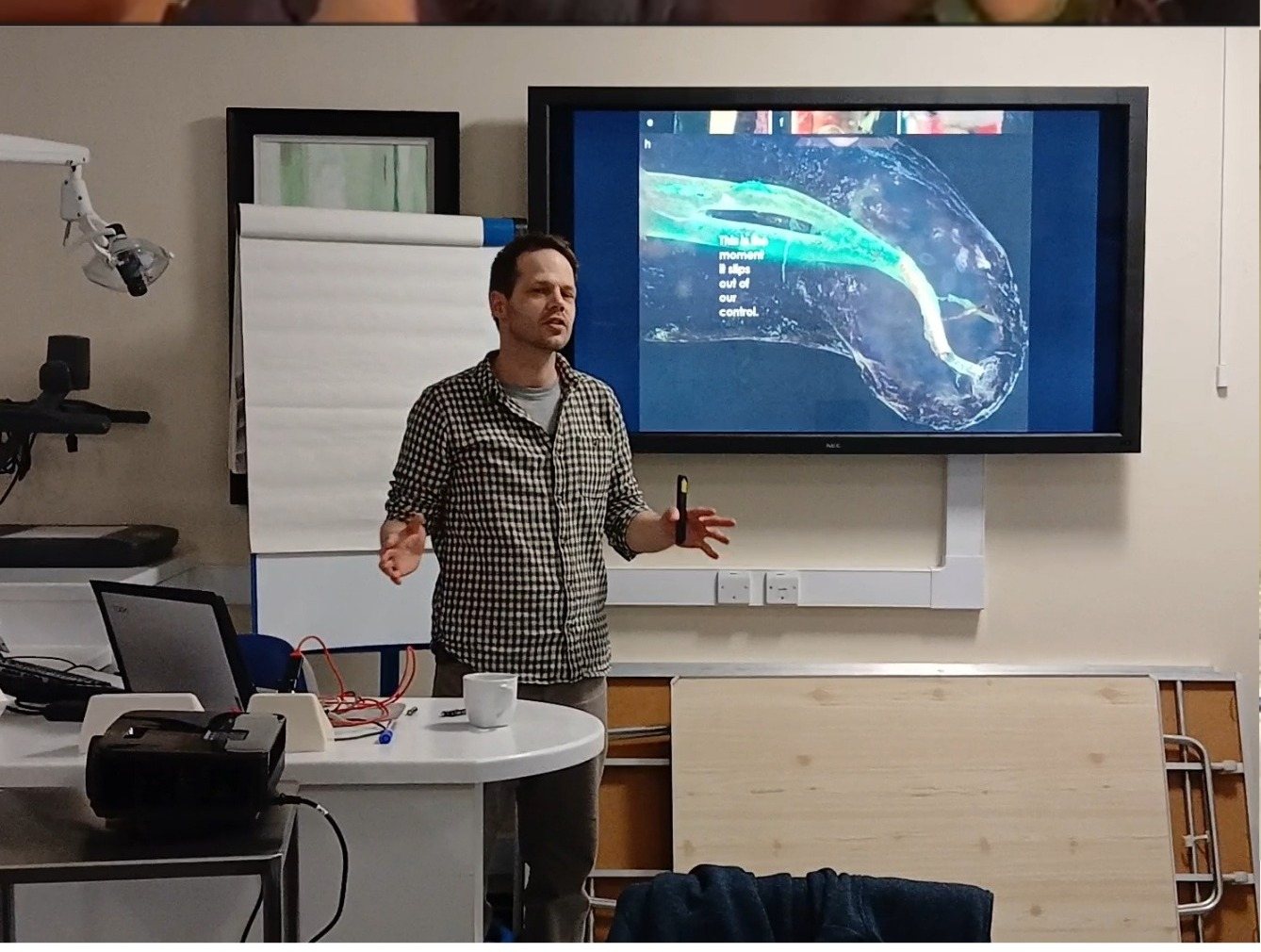 Dr John Barclay presenting clinical tooth wear content on screen at a GDP training course